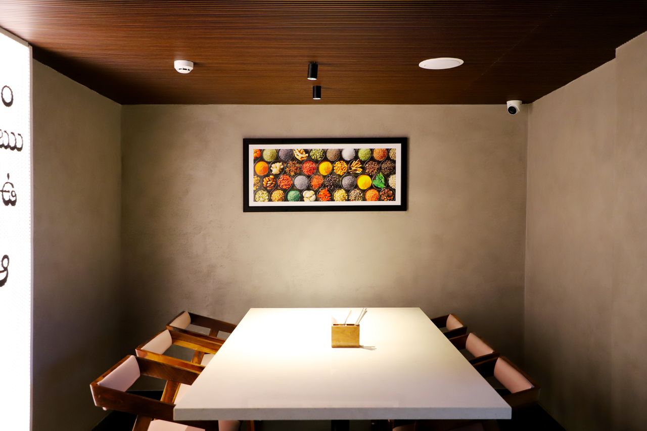 About Elegant dining room with a modern table, chairs, and colorful framed artwork. Perfect minimalist interior design.